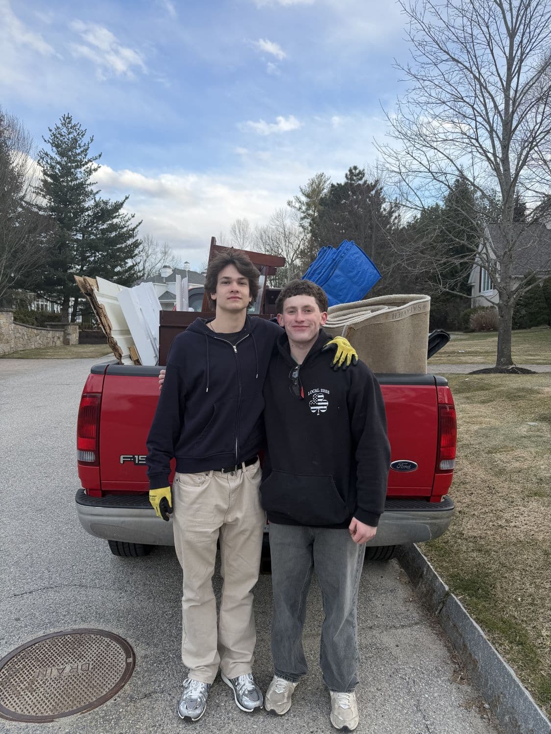 Junk ByeBye founders Dmitri Krasnov and Cooper Broslovsky in front of their loaded pickup truck